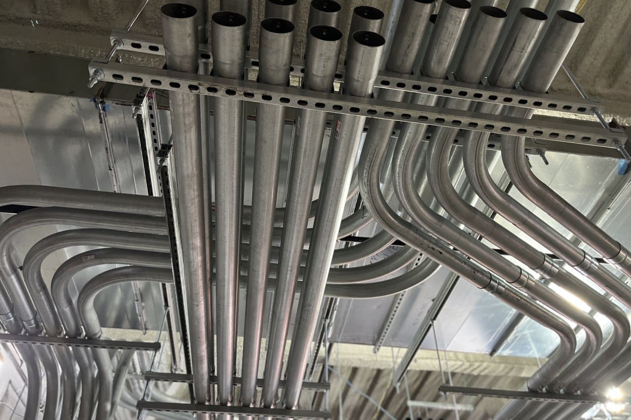 Metal pipes in a ceiling grid.