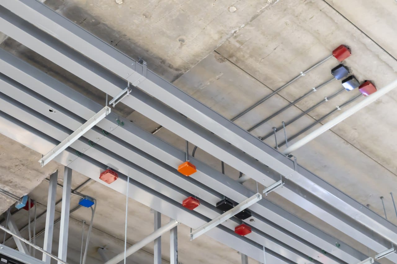 Metal ceiling with electrical conduit.