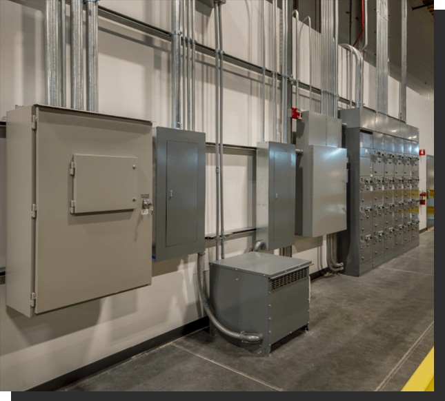 A large building with many electrical boxes on the side.