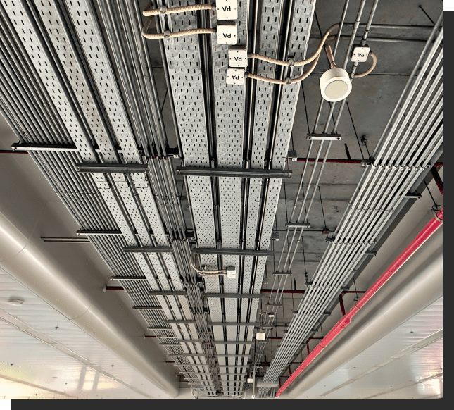 A ceiling with many wires hanging from it.