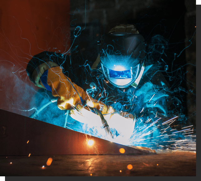 A man welding with blue light shining on him.